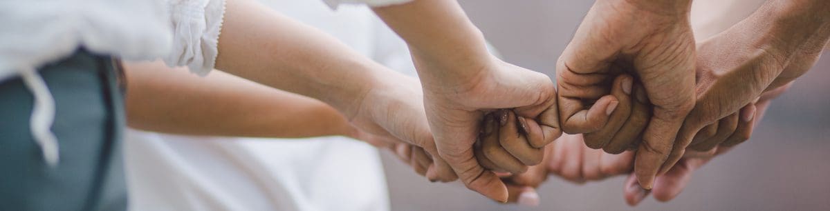 a group of hands making a fist in a circle