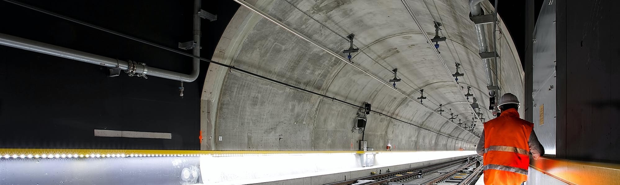 a rail engineer working on the tracks in a tunnel