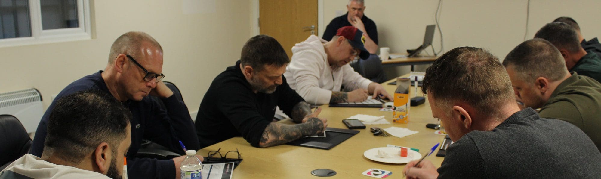 9 Railway contractors writing on notepads, part of a presentation